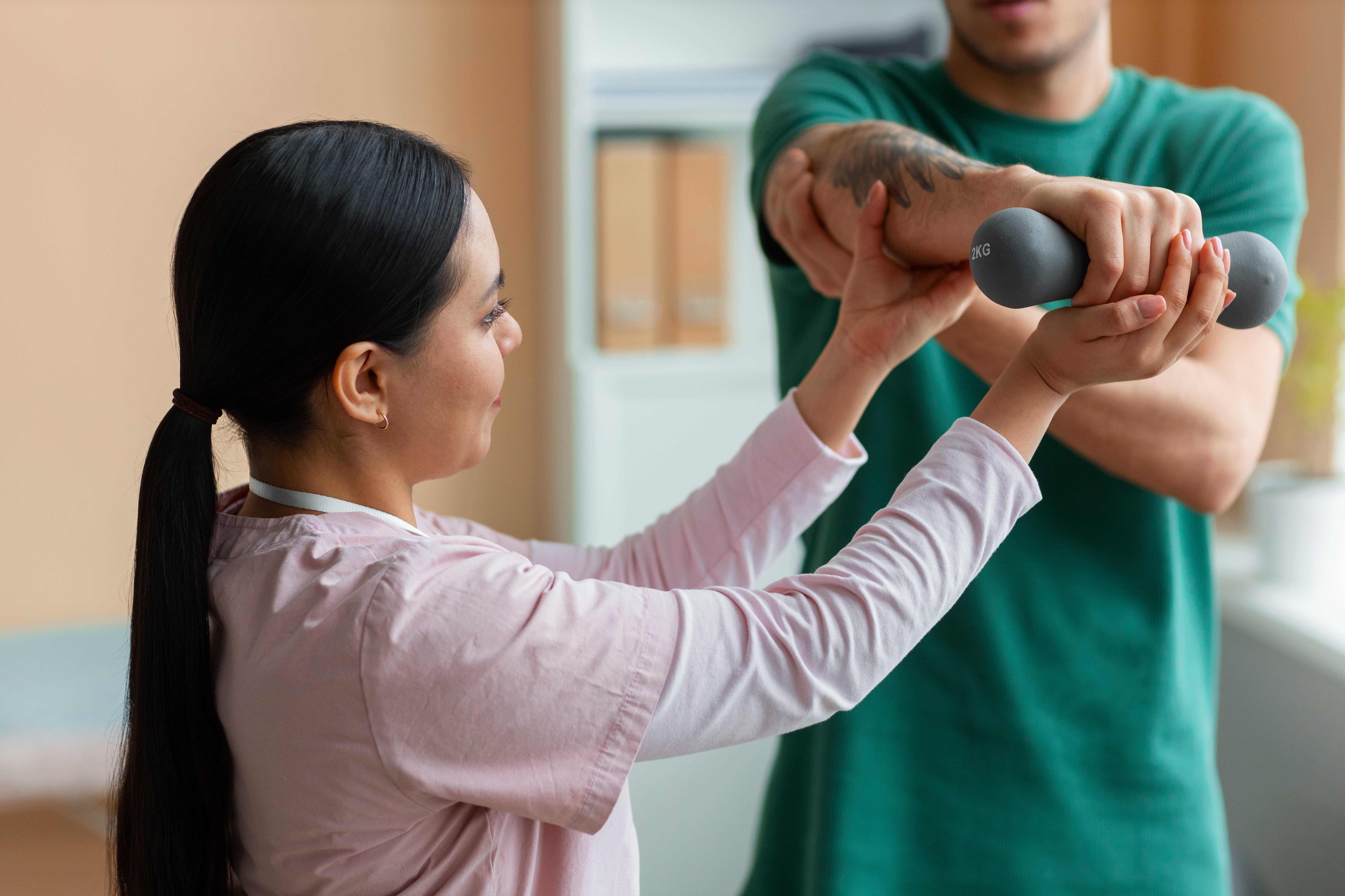 doctor-helping-patient-rehabilitation